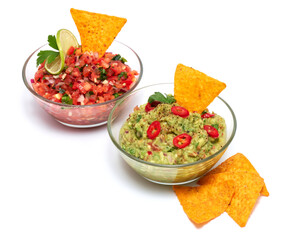 Salsa and guacamole Mexican dip sauce served in glass bowl with nachos or tortilla chips isolated...
