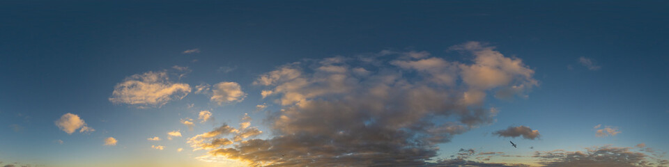 Panorama of a dark blue sunset sky with golden Cumulus clouds. Seamless hdr 360 panorama in spherical equiangular format. Full zenith for 3D visualization, sky replacement for aerial drone panoramas.