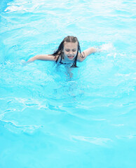 Child relaxing in swimming pool