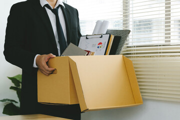 Resignation. businessmen holding boxes for personal belongings and resignation letters. Quitting...
