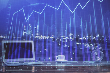 Forex market chart hologram and personal computer background. Multi exposure. Concept of investment.