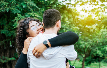 Close up of smiling teenage couple hugging, Teenage couple hugging outdoors, Close up of happy couple hugging in nature