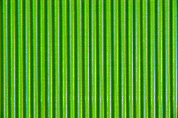 Obraz premium Corrugated green cardboard, glossy paper background with copy space