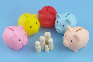 Five piggy banks around family people figures. Family savings concept. 