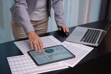 Businesswomen using digital tablet review assessment and evaluation of corporate for business restructuring. Business and Financial concept.