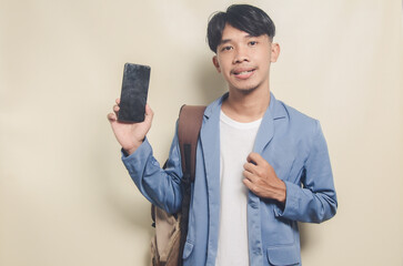 young man wearing college suit showing phone screen on isolated background