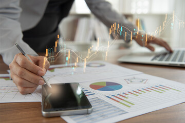 businesswomen using smart phone for data analysis investment portfolio in stock market with index stock market and chart with uptrend stock market graph.