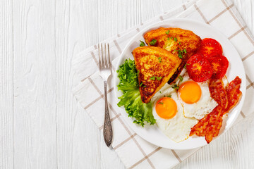 irish breakfast of fried eggs, bacon, potato farls