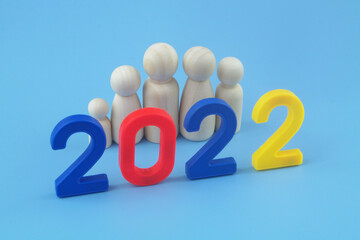 People and demography in 2022 concept. Wooden people figures as family members and numbers 2022. 