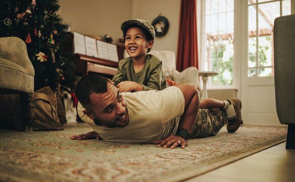 Army soldier spending quality time with his son at Christmas