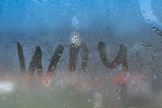 Inscription word why on a foggy window.