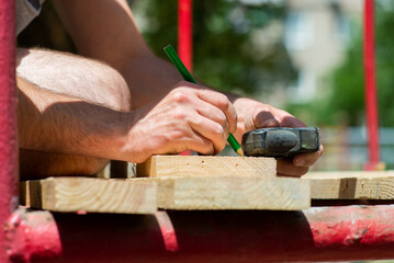 worker are engaged in work with wooden boards, close-up