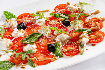 caprese salad in the white plate