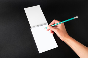 female hand writes on a white sheet, close-up, mock-up, template