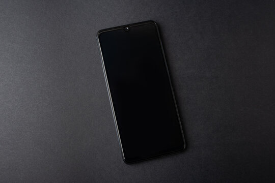 black, clean phone on a black background, template
