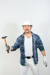 Male builder in a hard hat with a hammer on a white background