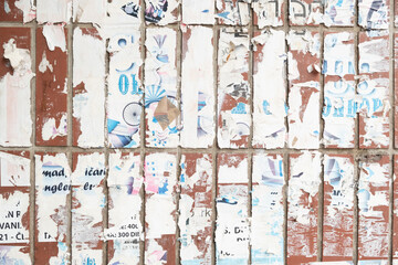 Torn old paper poster on a brick wall background