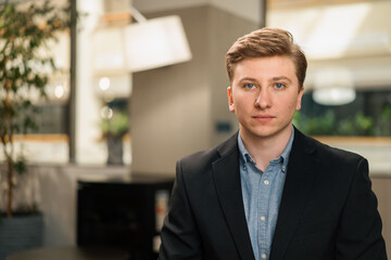 Fototapeta premium Young attractive businessman lawyer in a suit. Video conference, call, profile picture, handsome businessman portrait, professional profession, person concept
