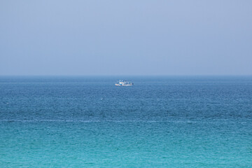A ship in the middle of the sea. horizon
