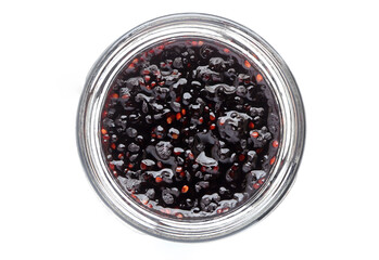 Close up of Sweet blackberry jam in glass jar isolated on white background.Top view.