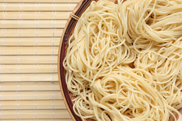 Close up of Delicious ramen noodles on bamboo colander. Top view, empty space for text.