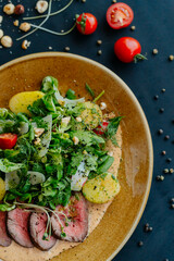 vegetable salad on a plate, black dining table, food for vegetarians, vegetarian dish