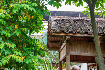 Fototapeta na wymiar Wooden hut and tile roof in Chinese garden