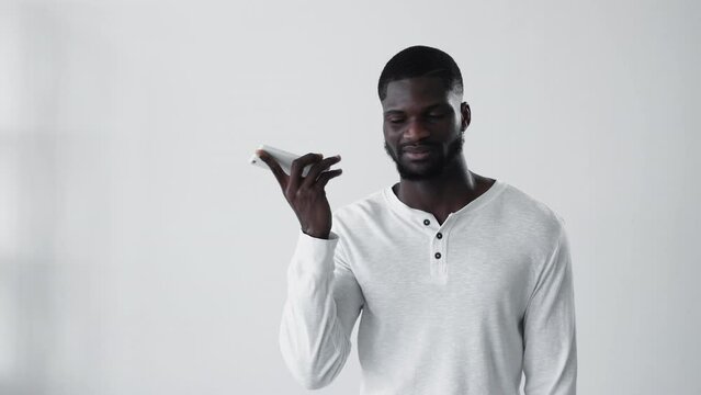 Boring phone call. Annoyed african guy. Boomerang animation. Mobile scam. Disturbed black man ignoring bla on cellphone gif loop isolated on white copy space background.