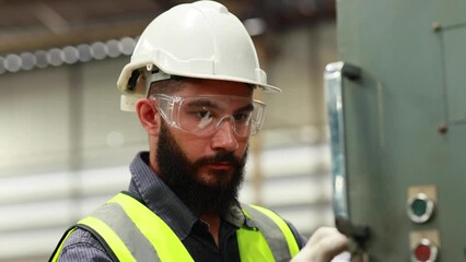 Professional mechanical engineering hispanic male operate lathe machine at metal factory.