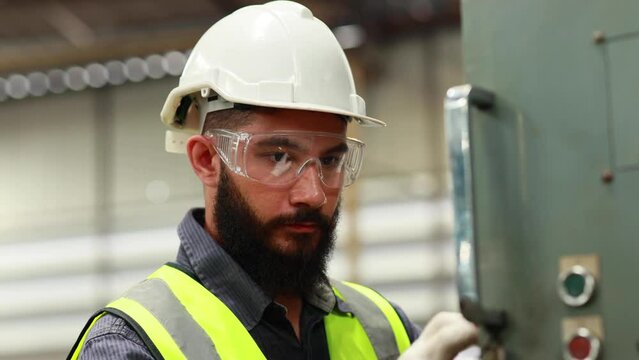 Professional mechanical engineering hispanic male operate lathe machine at metal factory.