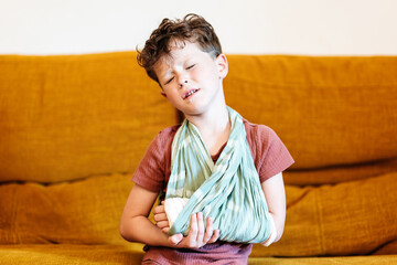 Boy suffering from severe pain in broken arm
