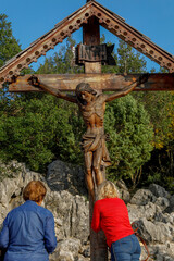 Pilgrims at the foot of the crucifix on top of the hill of apparitions, Podbrdo, Medjugorje, Bosnia...