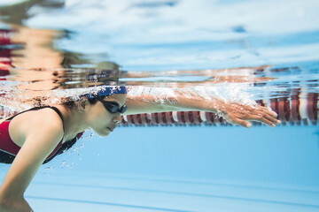 Woman swimming pool.Underwater photo..