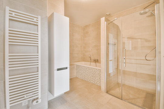 Bathtub near shower cabin