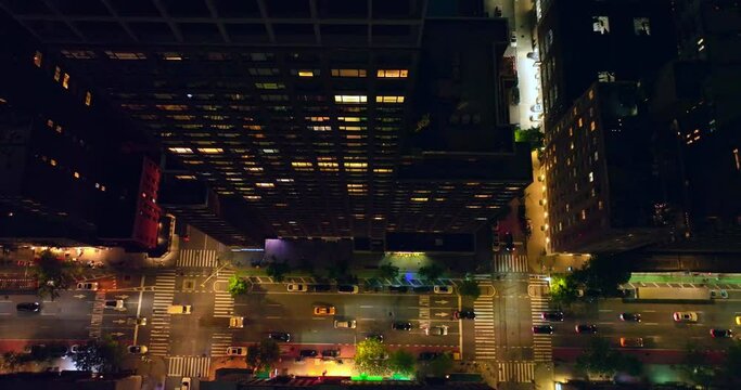 Transport moving by the light roads of metropolis. Gaze at the busy traffic from bird's eye perspective.