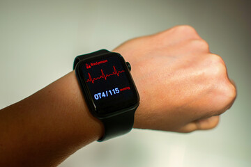  Close-up of a watch displaying blood pressure. Anonymous man wearing a digital smart watch during...