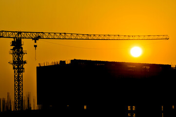 construction site with crane in sunrise