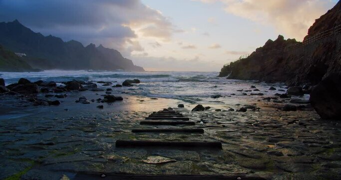 Enbankment. Benijo beach, steps go into the water. Big waves break on the protrunding rocks. Anaga on the north of Tenerife.