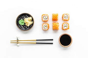 Sushi rolls set with salmon flatlay on table, top view