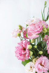 Pink lisianthus flowers in white vase