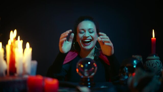 Female fortune-teller laughing, predicting bad future, enchanting ill-wishers