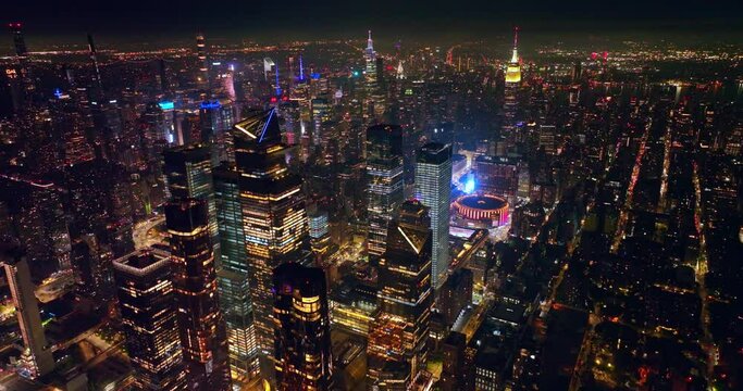 Scenic view of outstanding New York sparkling with lights at night time. Amazing skyscrapers with shining tops standing out from panorama. Top view.