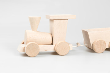 Wooden train with trolleys on white background