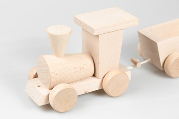 Wooden train with trolleys on white background
