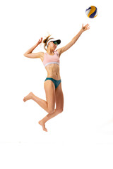 Studio shot of one fitness young woman, volleyball player in sports swimsuit playing bach...