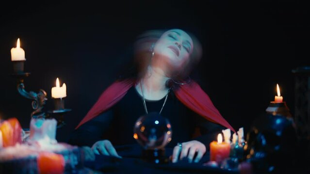 Black witch falling into a trance state, communicating with ghosts, possession