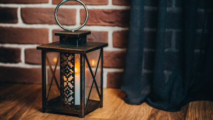 iron lamps with a burning candle near the Christmas tree