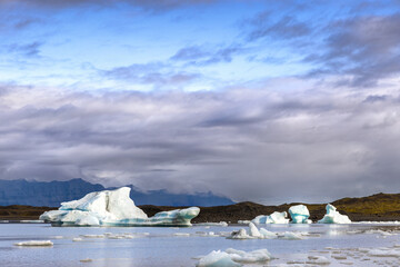 Fjallsarlon Glacier Lagoon, Iceland. Blue icebergs float and are reflected in the water. Part of the Vatnajokull National Park