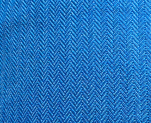 Pattern of blue fabric close-up with triangular shaped stitching