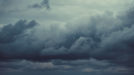 Storm sky with dark grey cumulus clouds.  Thunderstorm
